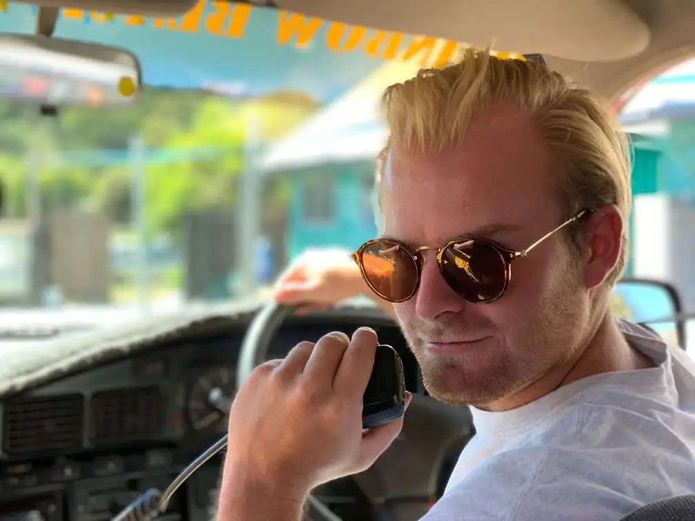 A backpacker at the wheel, talking into a CB radio handset